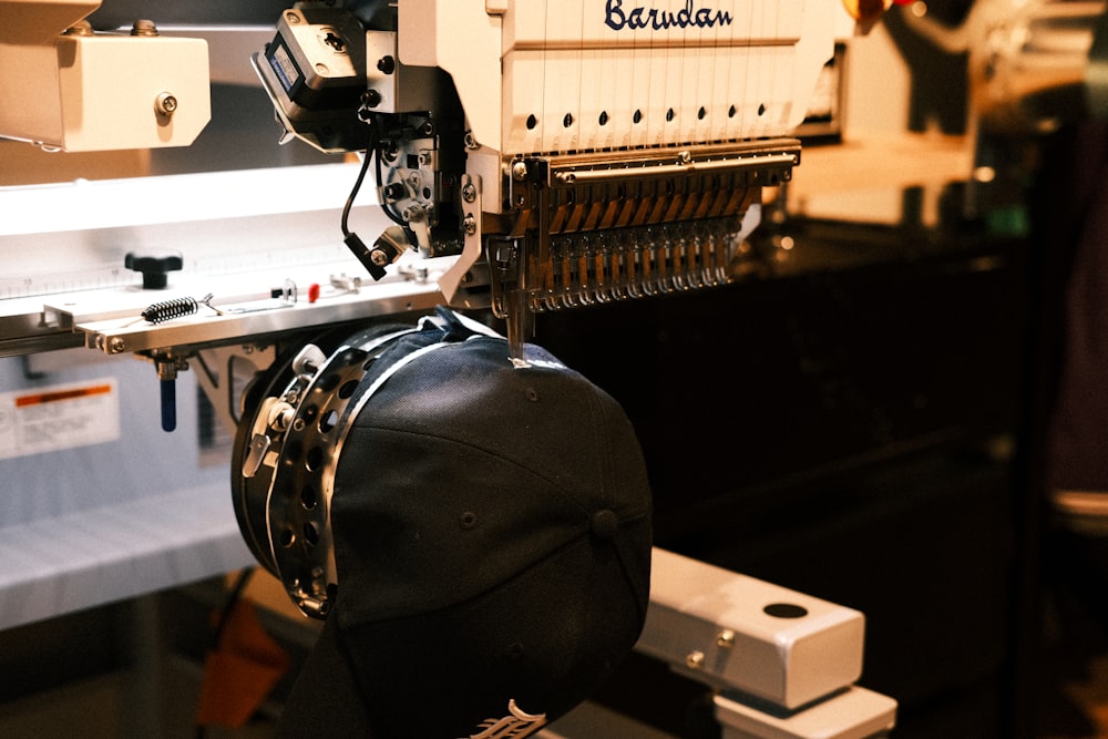 Custom Embroidery Multi-head commercial embroidery machine stitching a cap at Delaware County Shirt Printing, Upper Darby PA